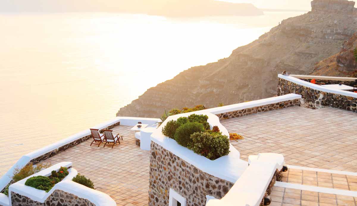 two chair at the top of a viewing area in santorini greece